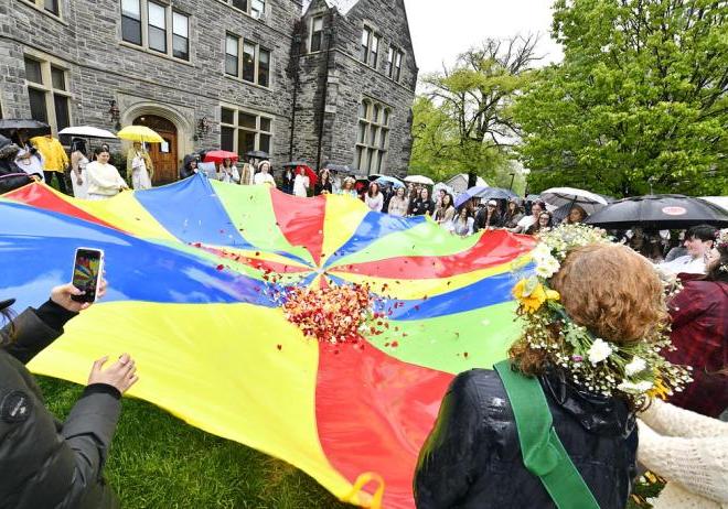 Flowers are tossed in the air using a parachute on May Day
